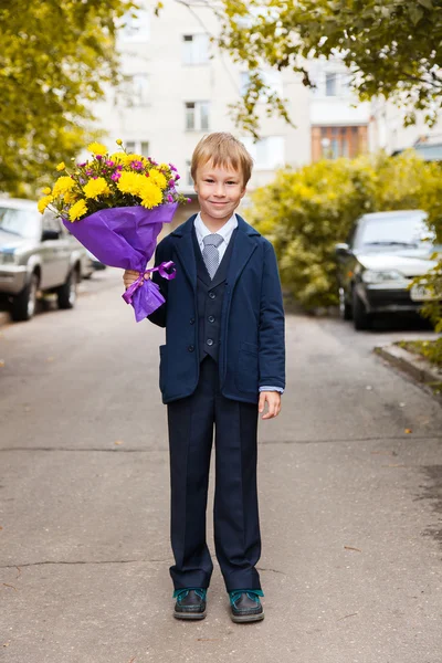 Boy with flowers  ready to go in  school