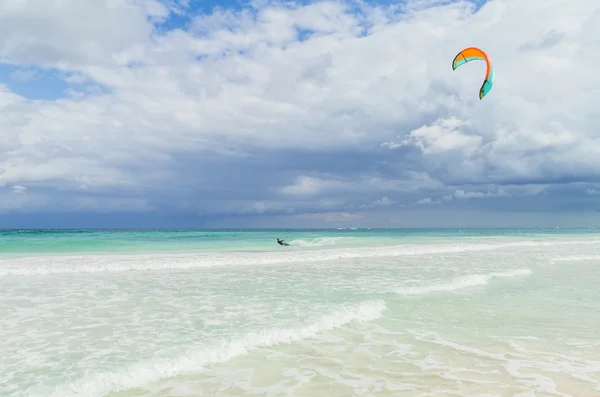 Kitesurfing in the beautiful sea. Kitesurfer in action on clear blue tropical water, Mexico