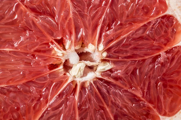 Background of ripe grapefruit Slice on black, fresh fruit texture closeup