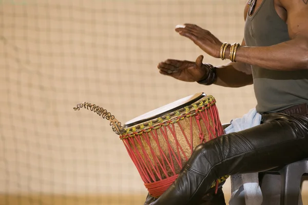 African man planing drum