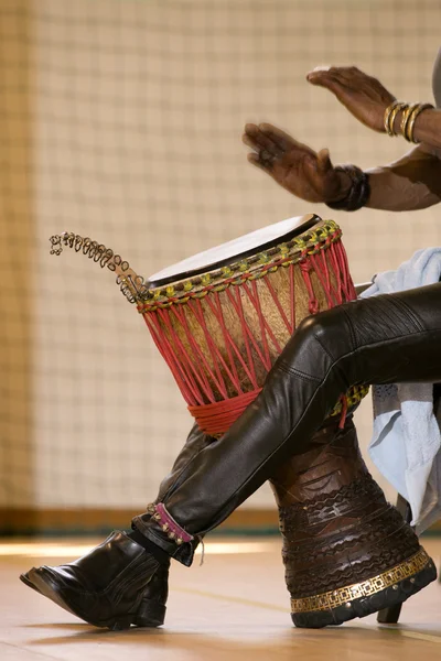 African man playing traditional instruments