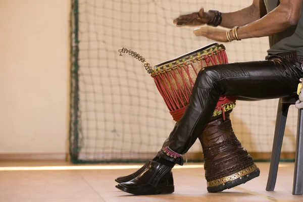 African man playing traditional instruments