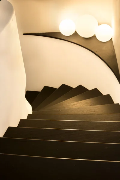 Curving staircase with brown slate steps