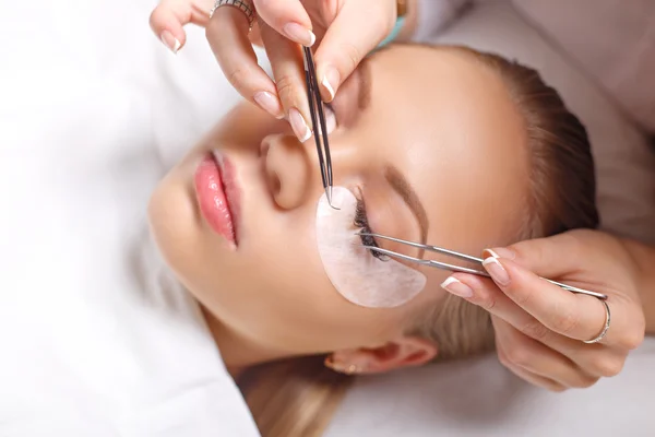 Eyelash Extension Procedure. Woman Eye with Long Eyelashes. Lashes, close up, selected focus.