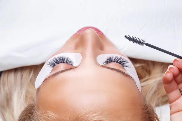 Eyelash Extension Procedure. Woman Eye with Long Eyelashes. Lashes, close up, selected focus.