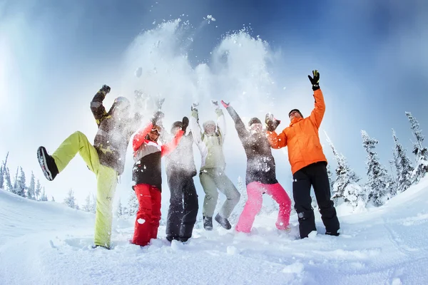 Group of friends snowboarders having fun