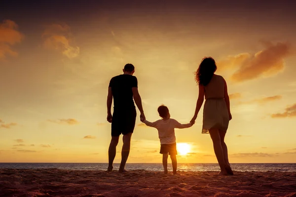 Family standing on sunset