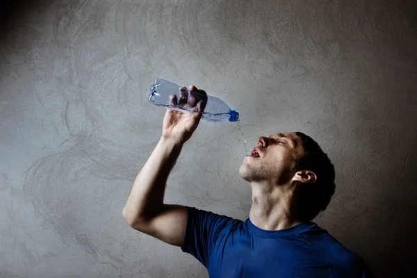Muscle man drinking water