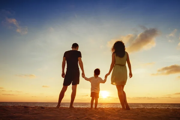 Family standing on sunset