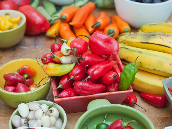 Assortment of Peruvian hot chili peppers on wooden table top