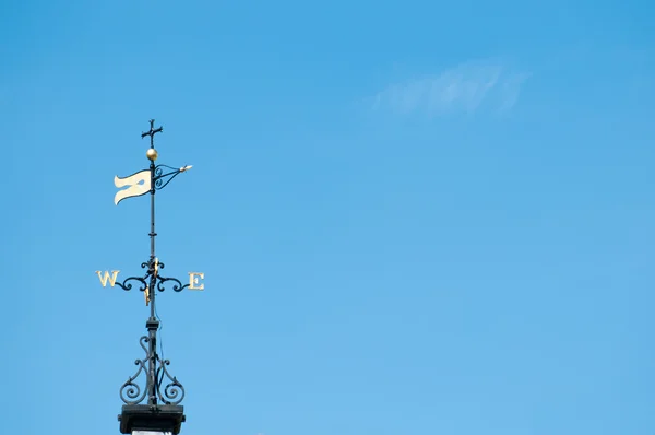 Weather vane in clear blue sky