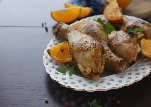 Roasted chicken legs in cast iron skillet, selective focus