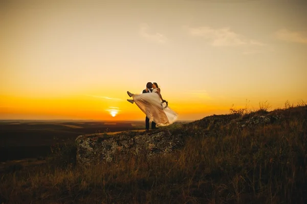 Silhouettes of couple at sunset