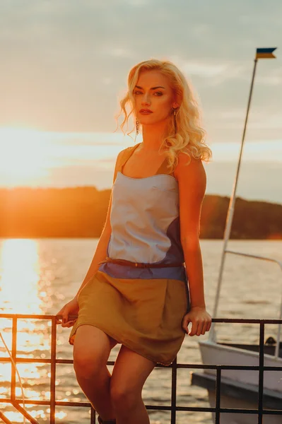 Beautiful blond girl watching sunset