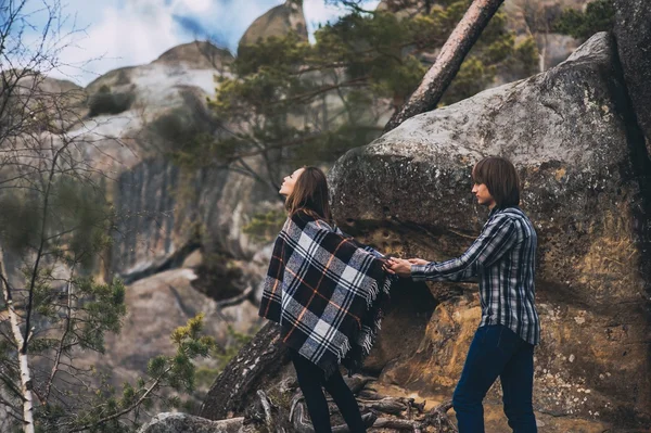 Young couple holding hands near mountains