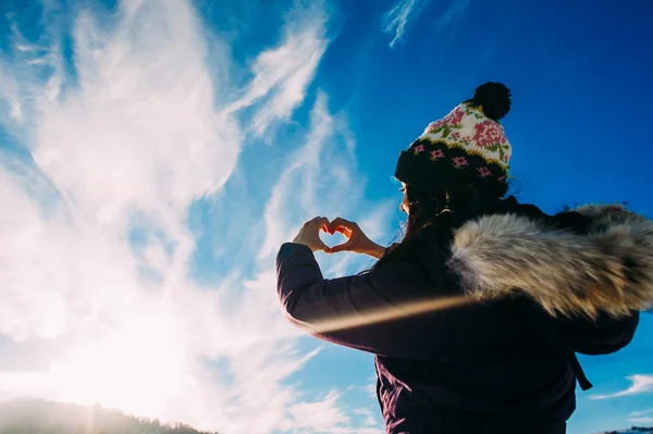 Beautiful stylish woman in snowy mountains