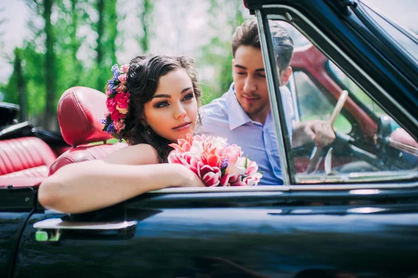 Young couple in vintage car