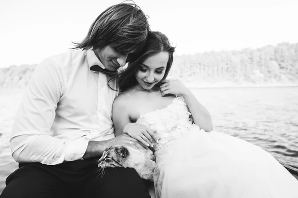 Couple on a boat with a cat