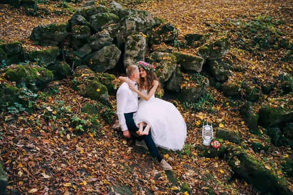 Newlyweds walk in the autumn forest