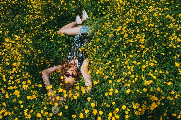 Girl in a field of yellow flowers