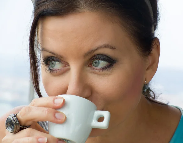 Pretty young lady drinking coffee