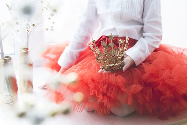 Little princess with a crown in the hand