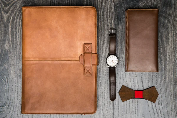 Top view of mans accessories on dark background.