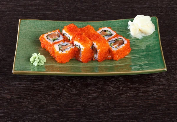 Sushi rolls on a plate with flying fish roe