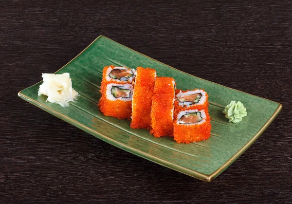 Sushi rolls on a plate with flying fish roe