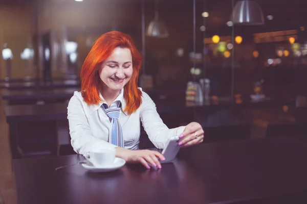 Businesswoman drinking coffee / tea and in a coffee shop