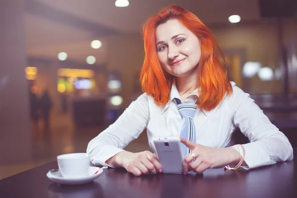 Businesswoman drinking coffee / tea and in a coffee shop