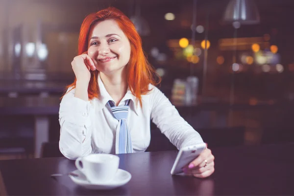 Businesswoman drinking coffee / tea and in a coffee shop