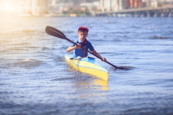 Young people are kayaking on a river in beautiful nature.