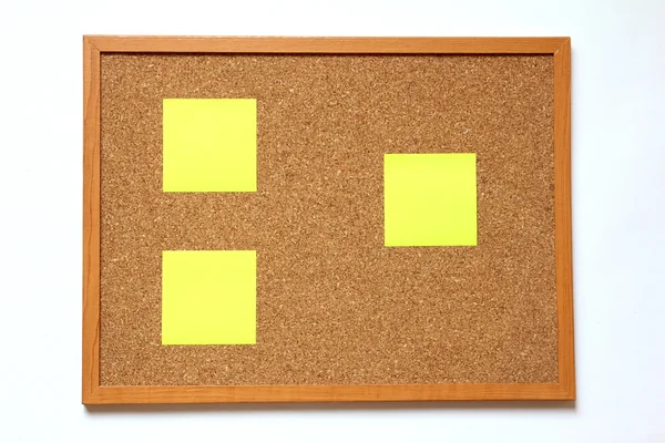 Cork board with paper note placed on white background