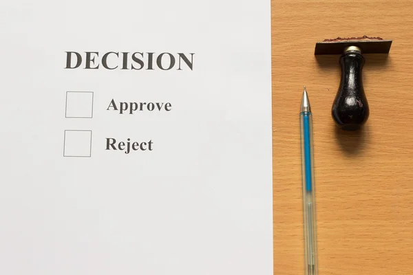 Paper with decision, approve, reject wording, and rubber stamp,p