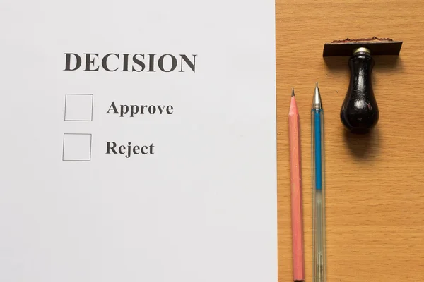 Paper with decision, approve, reject wording, and rubber stamp