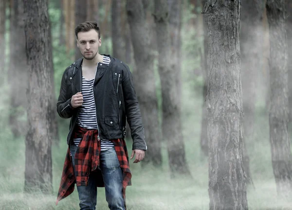 Man standing in the misty forest.