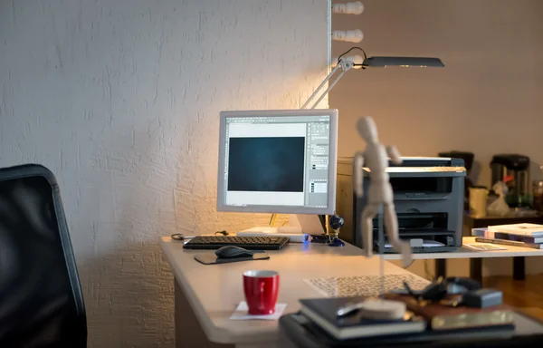 Desk with computer with a red cup