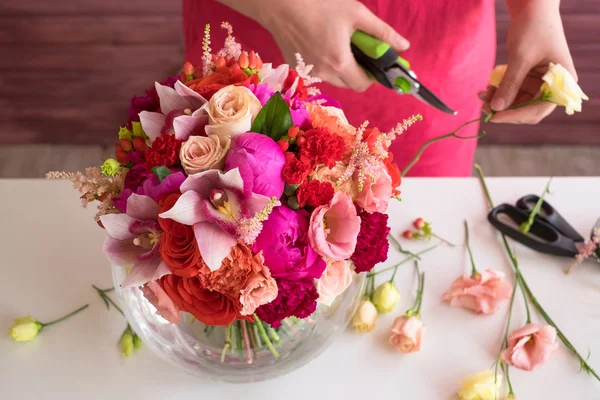 Girl florist making a wedding bouquet