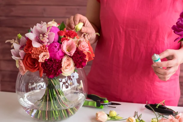 Girl florist making a wedding bouquet