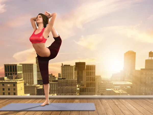 Yoga woman doing poses on city rooftop