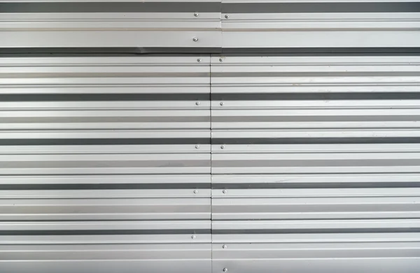 Stripped garage metal door texture in grey color