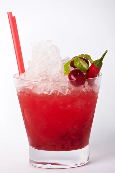 Red cocktail drink with ice, lime and chili isolated on white background