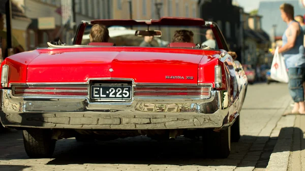 HAAPSALU, ESTONIA - JULY 16, 2016. Old retro red car back with people inside, American Beauty Car Show 2016.