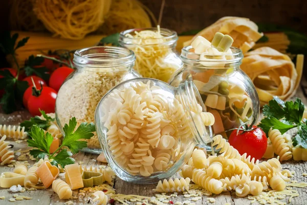 Dry Italian pasta spiraline in glass jars