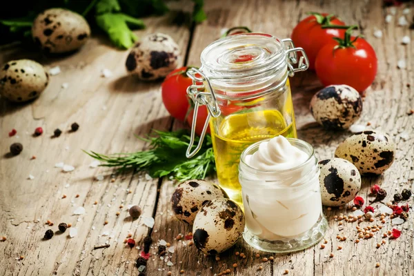 Mayonnaise sauce with quail eggs in a glass jar