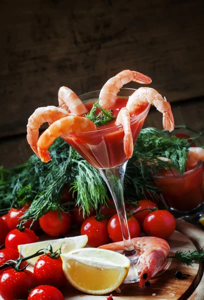 Peeled shrimp with tomato sauce in a martini glass