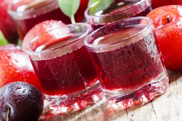 Fresh fruit juice of red plums and peaches