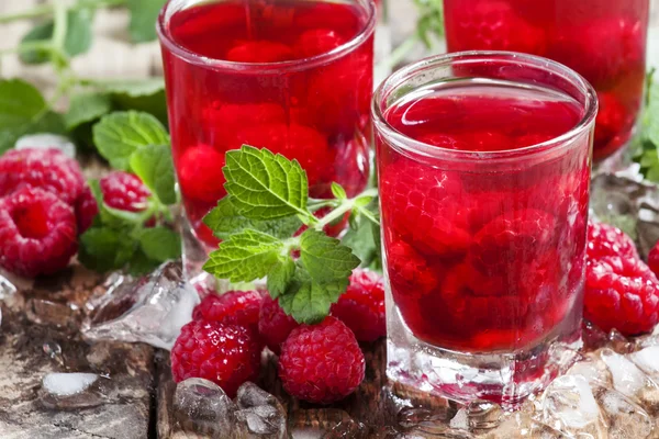 Refreshing raspberry drink with berries, ice and mint