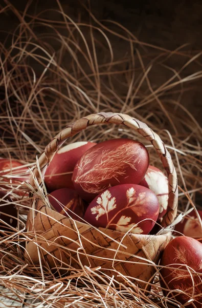 Easter brown egg with a pattern of grass, dyed in onion skins